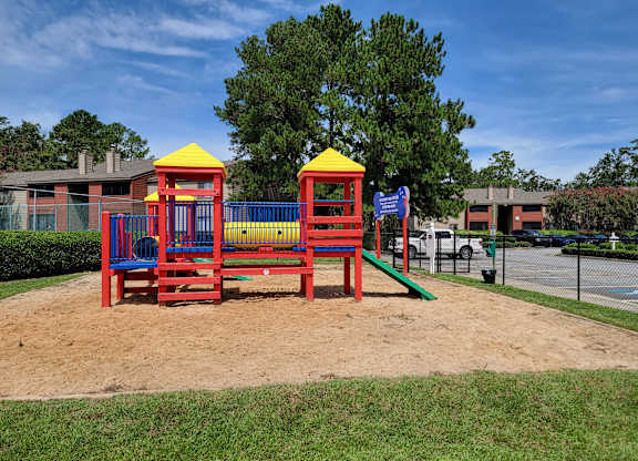 a playground with benches and slides in a park